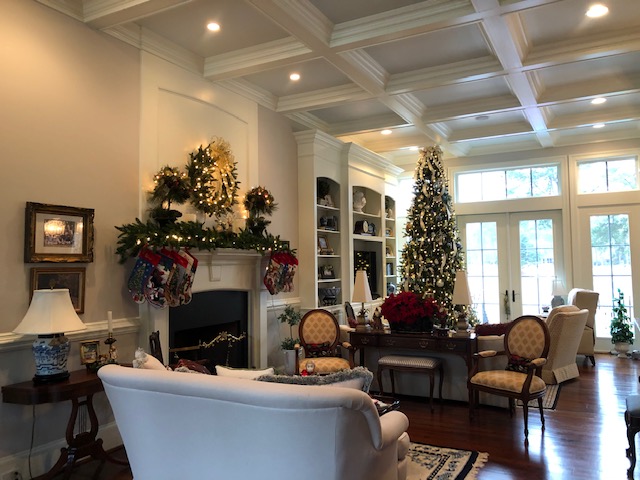 Living room in nice home with tall ceilings, wooden floor, christmas decorations